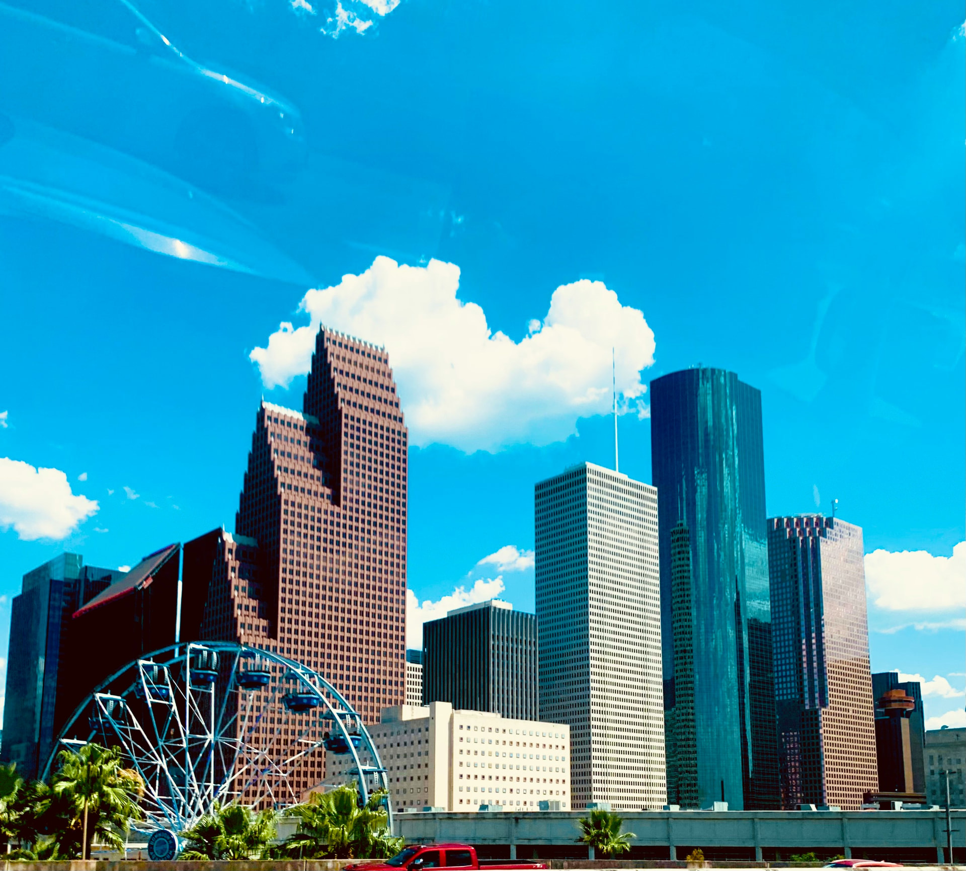Downtown Houston towers under a bright blue sky