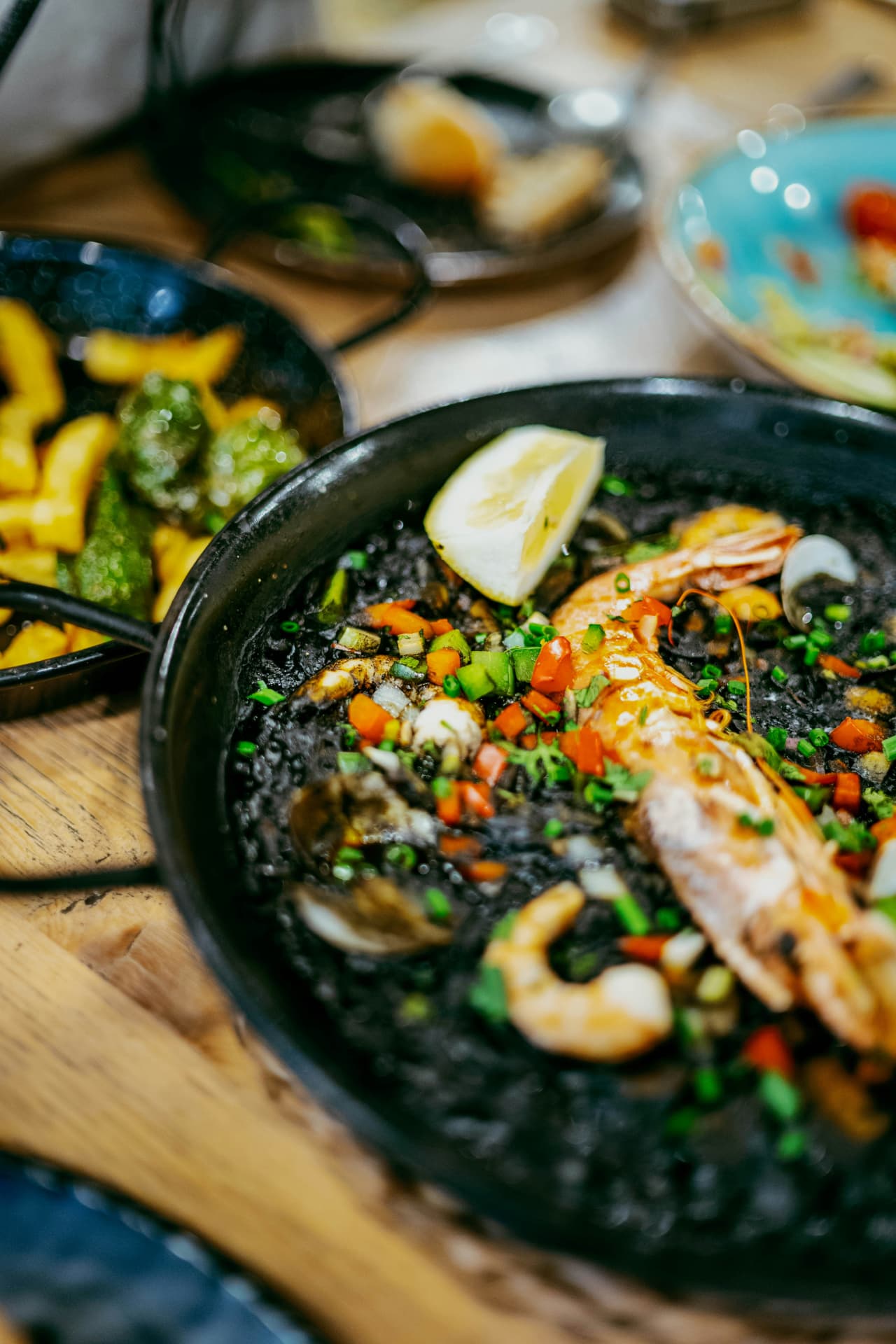 Black squid-ink rice with prawns, clams and lemon